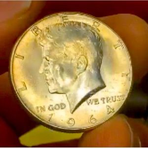 1964 Kennedy 1/2 dollar. Brilliant uncirculated. Toned. 90% silver